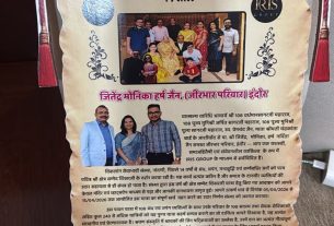 Poster scroll advertising a 15-year event by Viklang Seva Nandpuri, with group photo and IRIS logo, in Marathi/Hindi script.