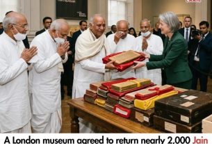News thumbnail: UK museum returns Jain manuscripts; officials present sacred folios to a woman as attendees watch in a gallery.